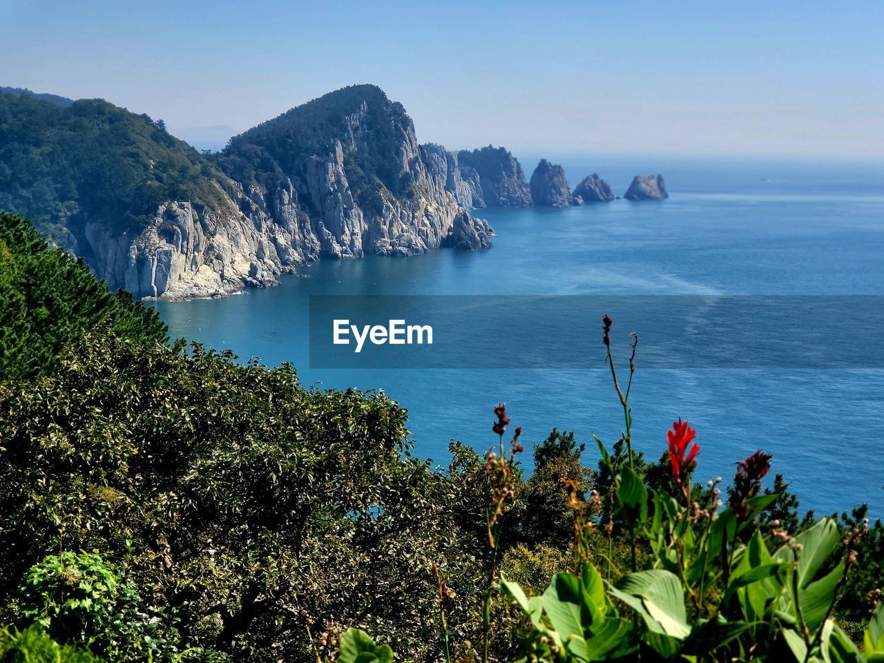 scenic view of sea and mountains against clear sky