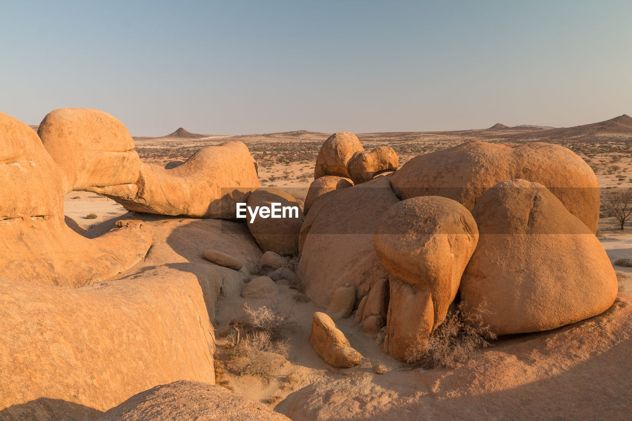 ROCK FORMATIONS IN DESERT AGAINST SKY