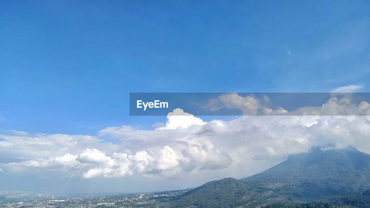 sky, cloud, mountain, environment, scenics - nature, mountain range, landscape, beauty in nature, blue, nature, travel, horizon, travel destinations, no people, tranquility, outdoors, land, snow, tourism, day, tranquil scene, winter, cloudscape, cold temperature, idyllic, non-urban scene, trip, holiday, vacation, plateau, mountain peak, copy space, water, sea, high up, sunlight