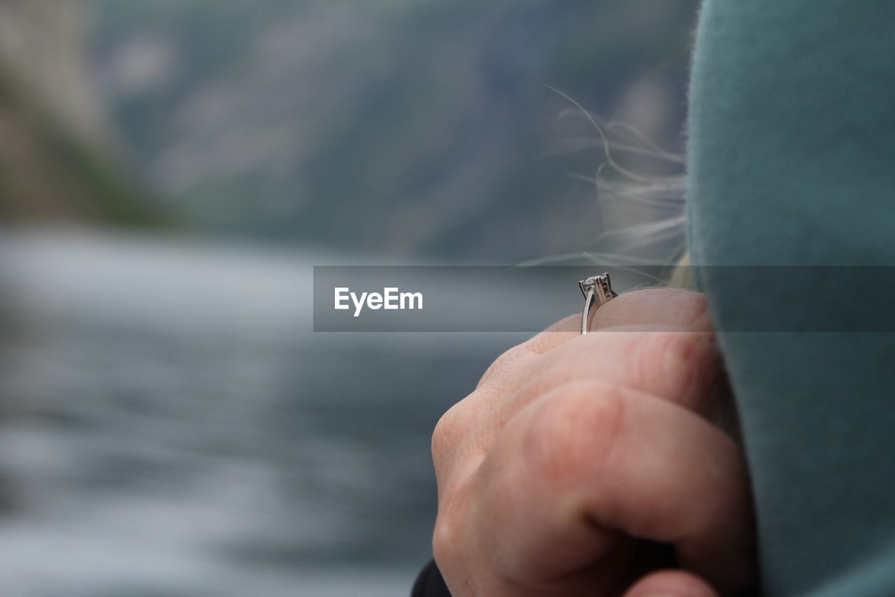 cropped hand of man holding insect