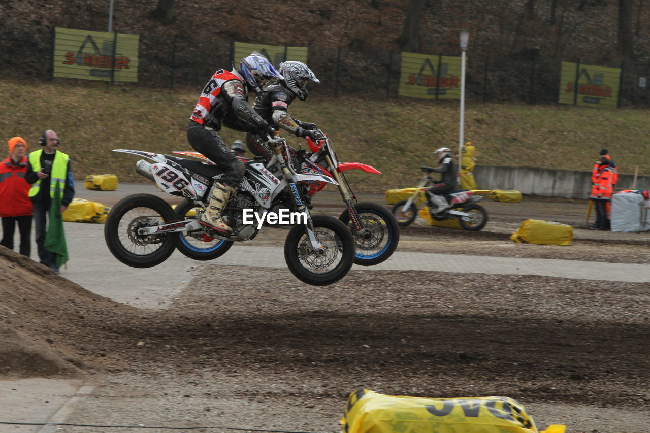 PEOPLE RIDING MOTORCYCLE ON CART