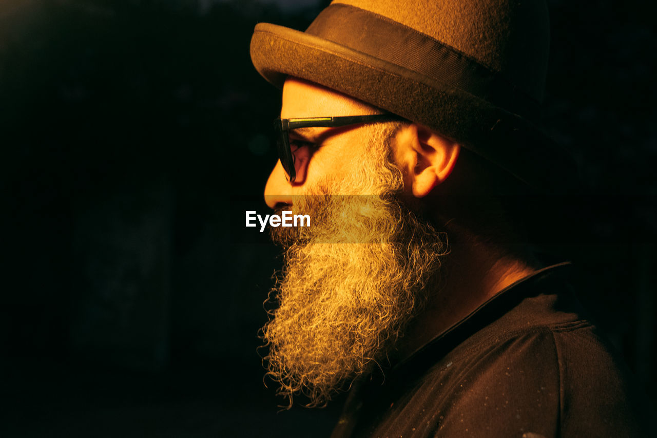 Portrait of trendy bearded man wearing hat and sunglasses