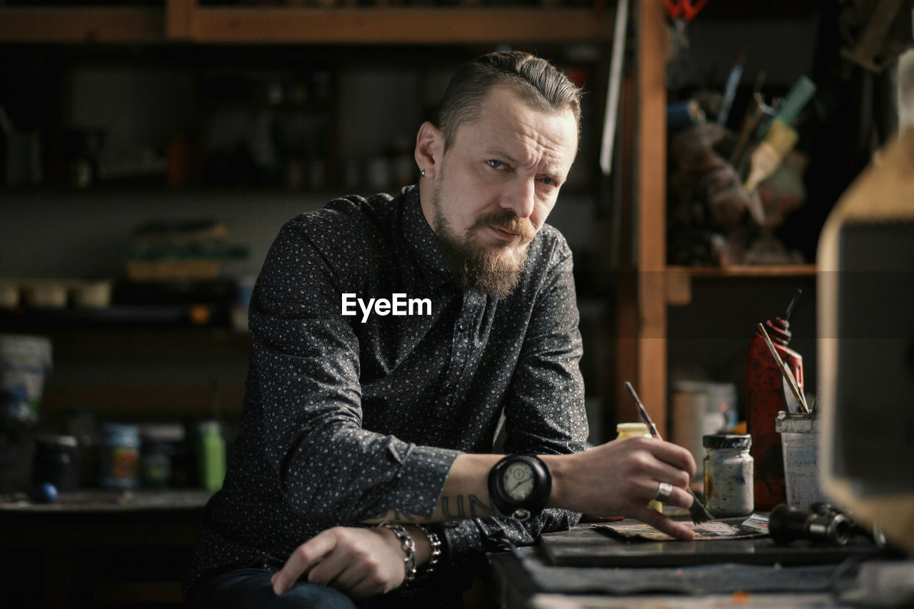 Portrait of man sitting at workshop