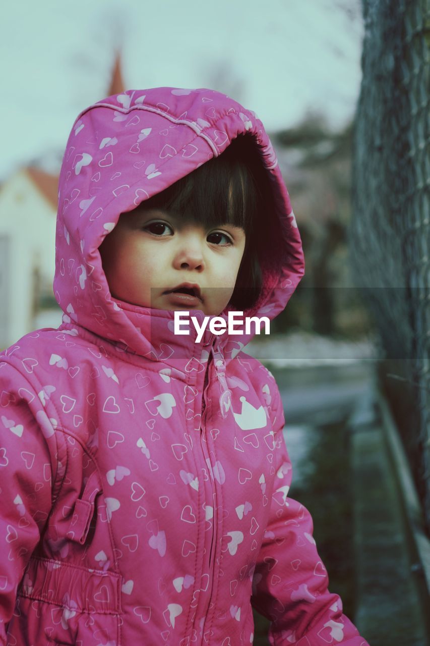 Close-up portrait of cute girl in pink jacket