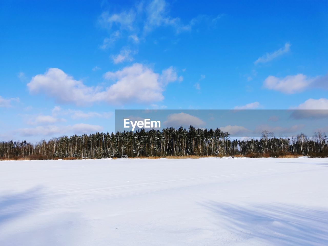 Scenic view of snow covered land against sky