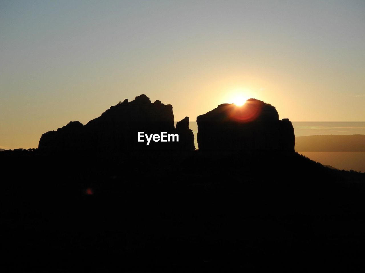 LOW ANGLE VIEW OF SILHOUETTE ROCK FORMATION