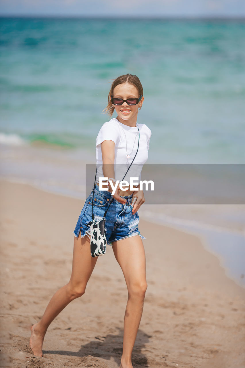 portrait of woman standing at beach