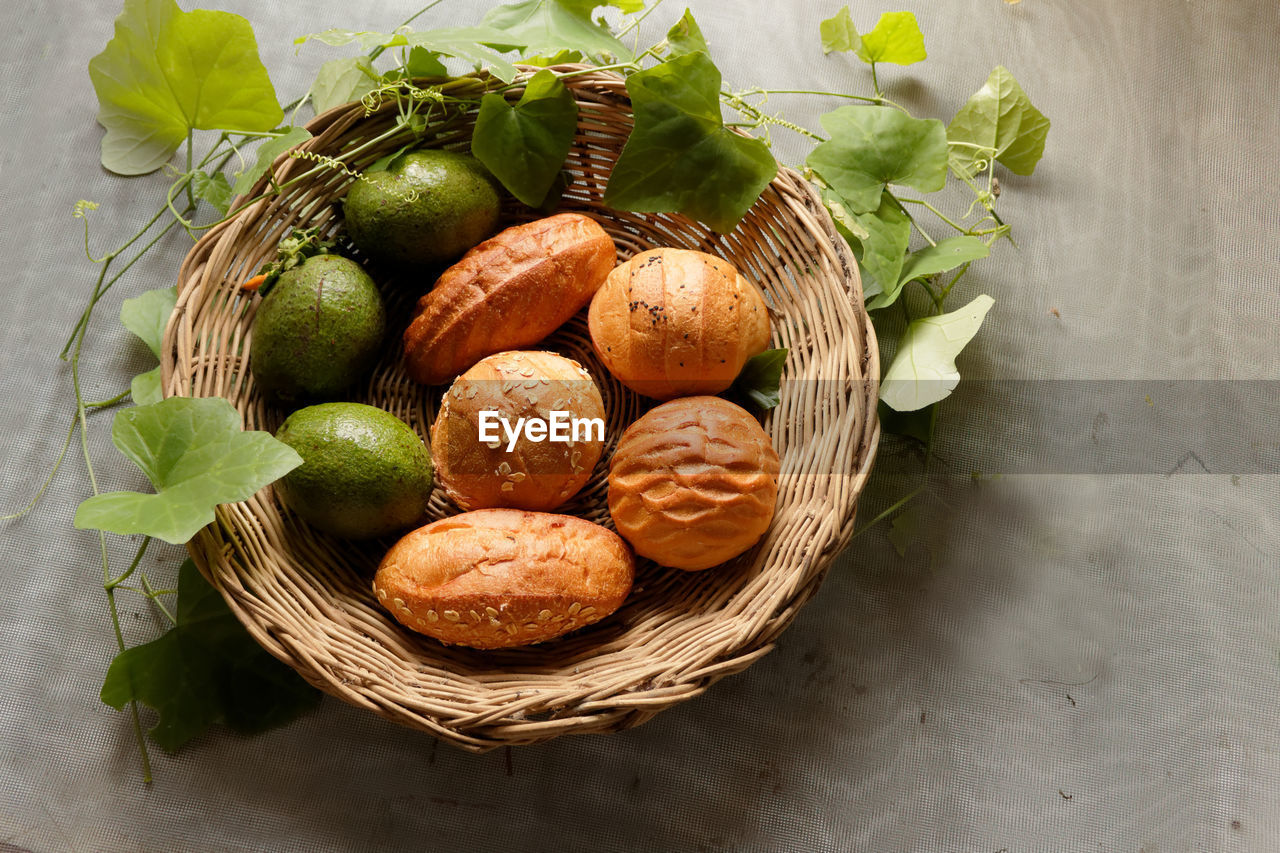 Bread and avocado in basket decorate by gourd leaf