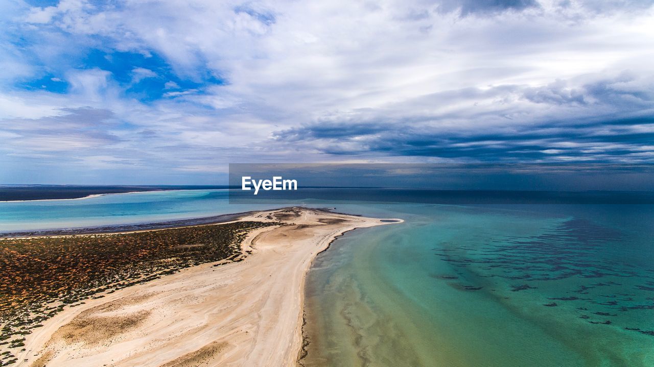 SCENIC VIEW OF BEACH AGAINST BLUE SKY