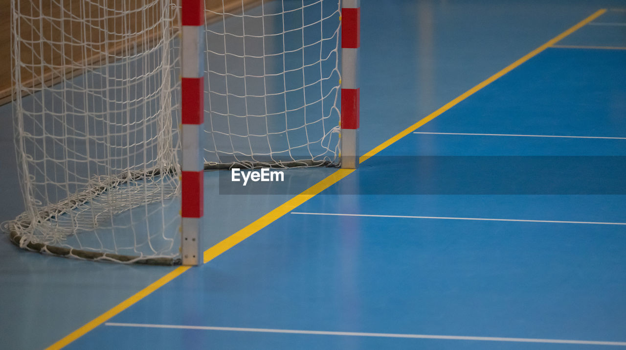 net, sports, net - sports equipment, floor, no people, sport venue, goal, line, absence, blue, flooring, soccer, competition, hockey