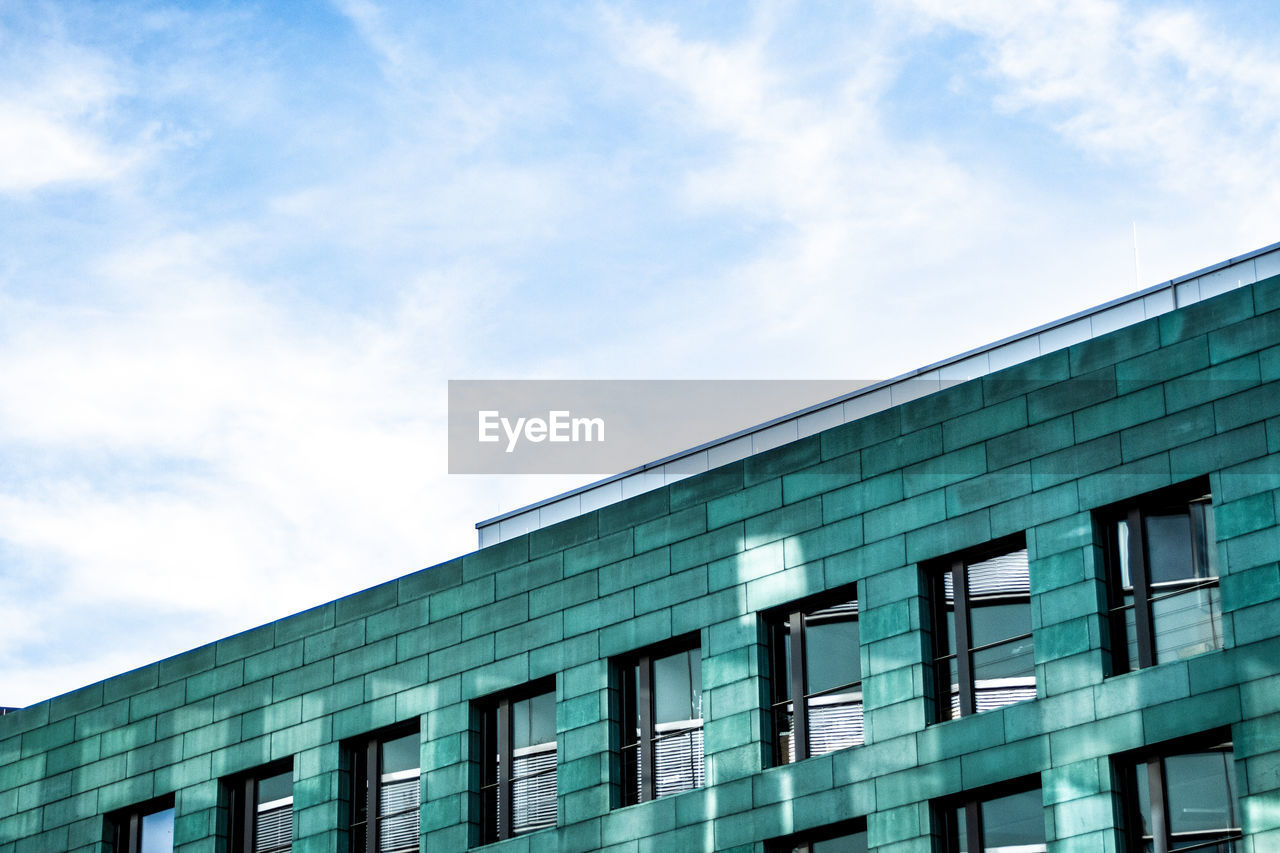 LOW ANGLE VIEW OF BUILDING AGAINST BLUE SKY