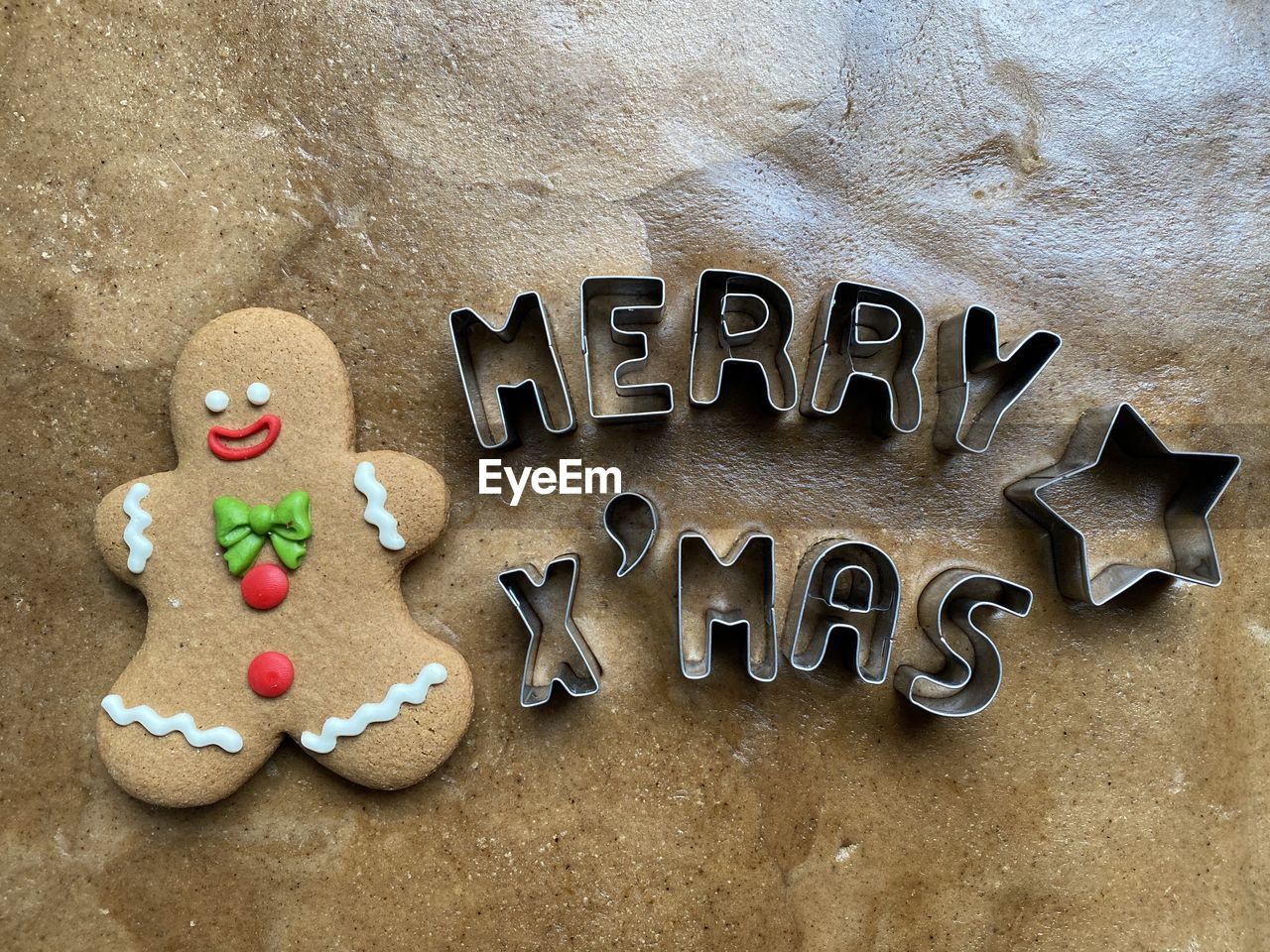 Close-up of gingerbread cookie with text cutters on table