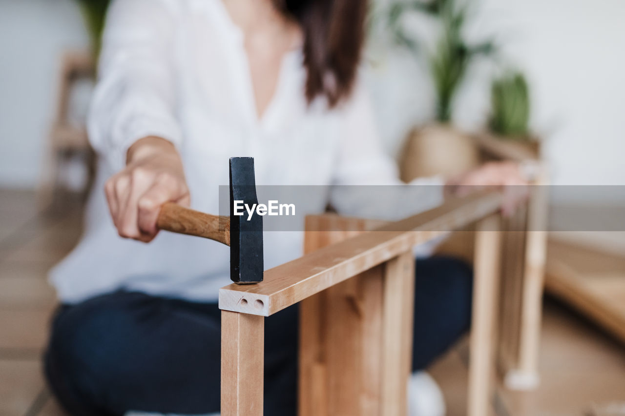 Woman sitting on wooden table