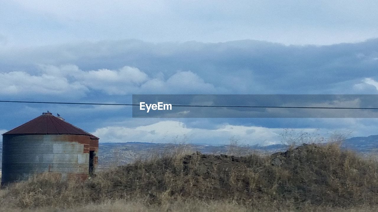 SILHOUETTE OF LANDSCAPE AGAINST CLOUDY SKY