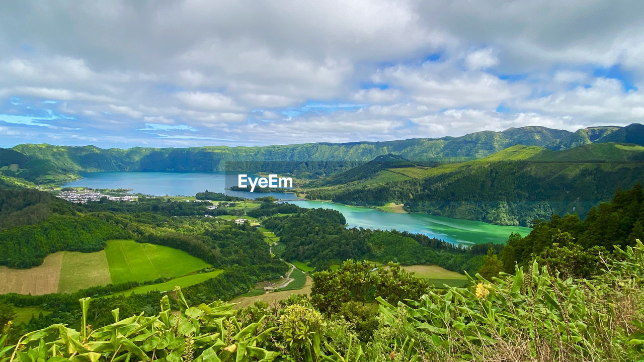 Scenic view of green landscape against sky