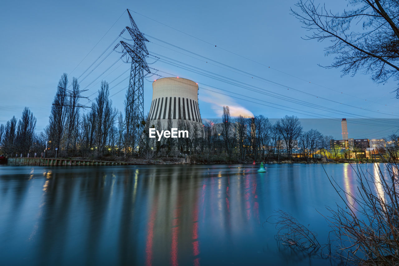 A power station in berlin at dusk with the river spree