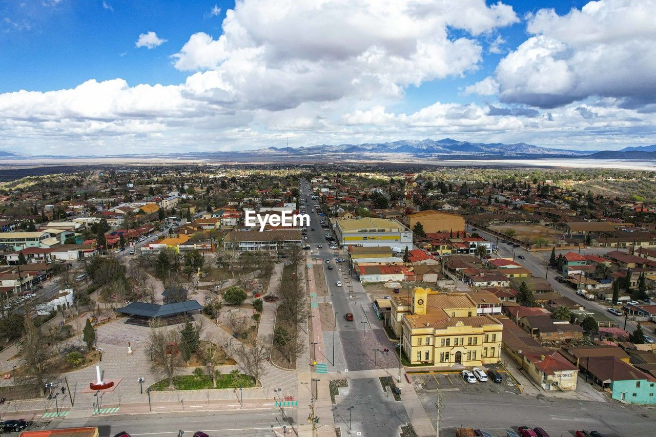 high angle view of townscape against cloudy sky