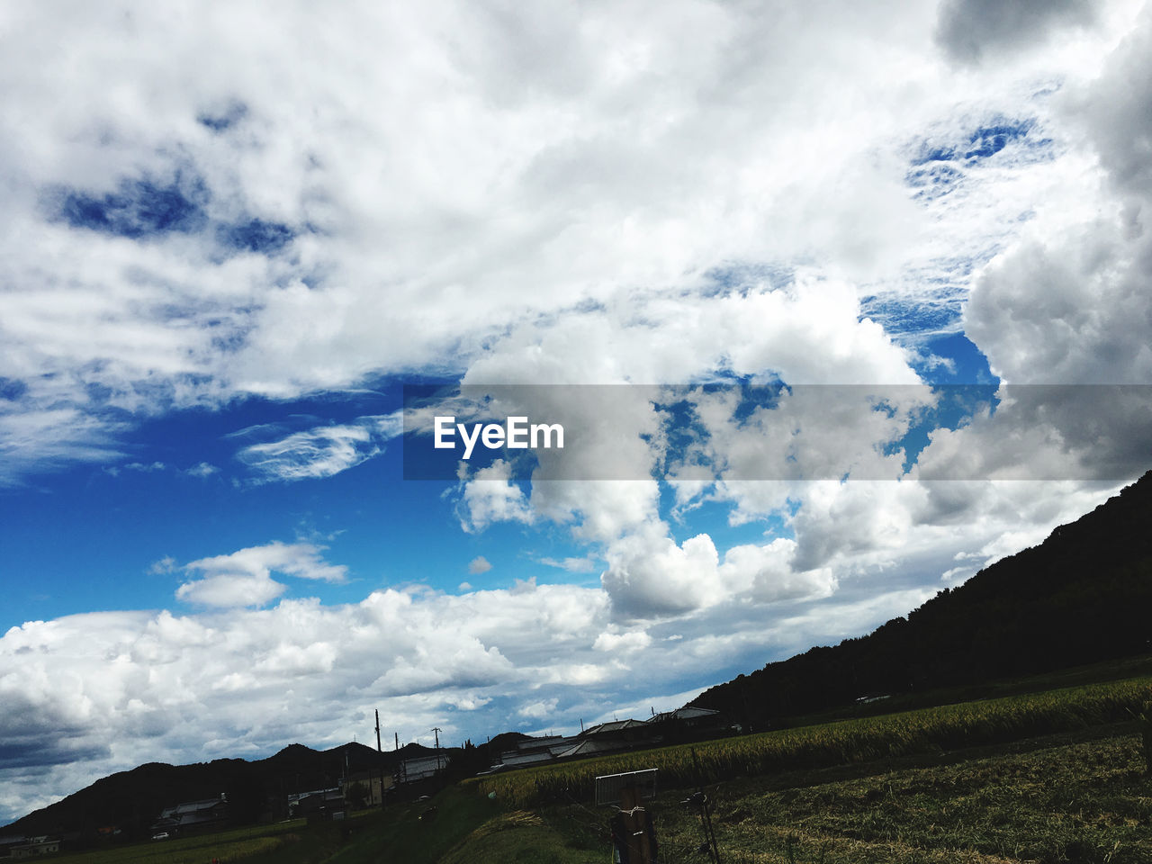 LOW ANGLE VIEW OF CLOUDS OVER LAND