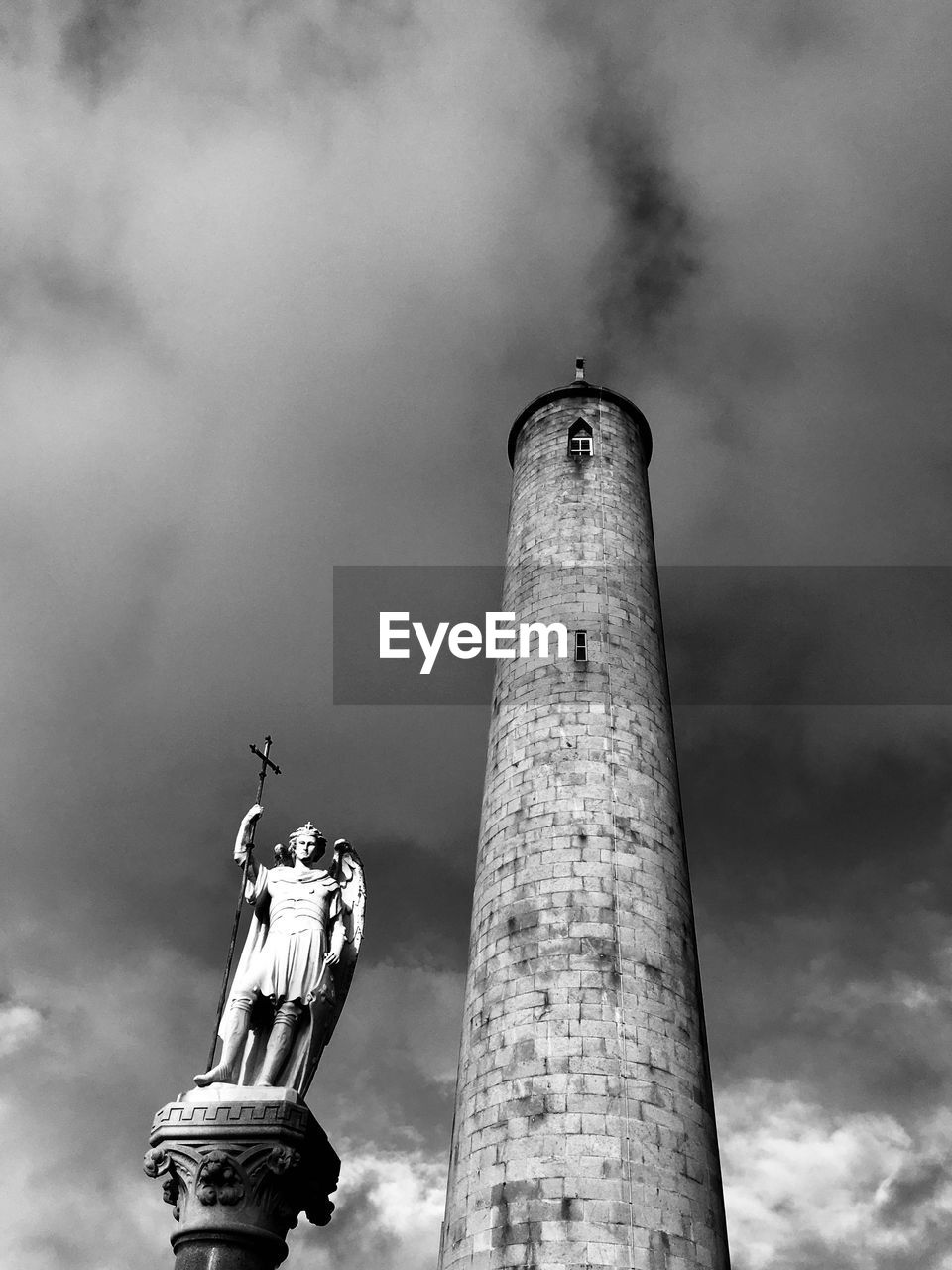 LOW ANGLE VIEW OF SMOKE STACKS AGAINST SKY