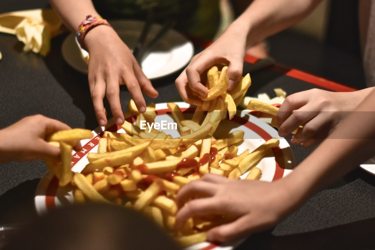 Children grabbing french fries