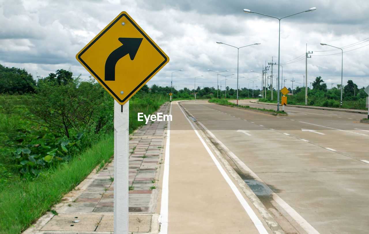 Road sign against sky