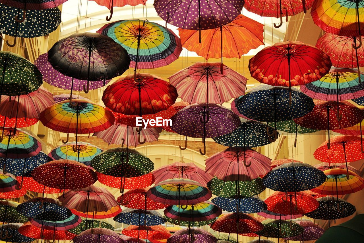 LOW ANGLE VIEW OF ILLUMINATED LANTERNS HANGING ON WALL