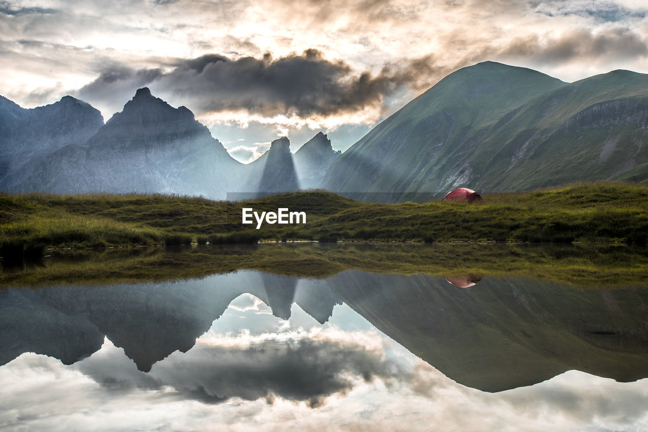 Scenic view of lake and mountains against sky