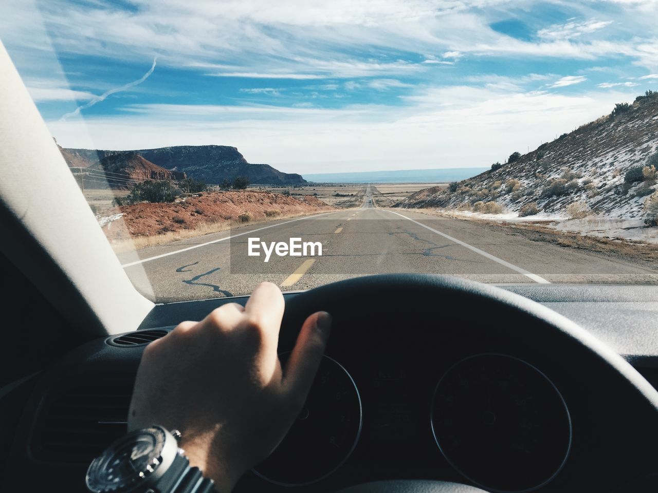 Person driving car on road