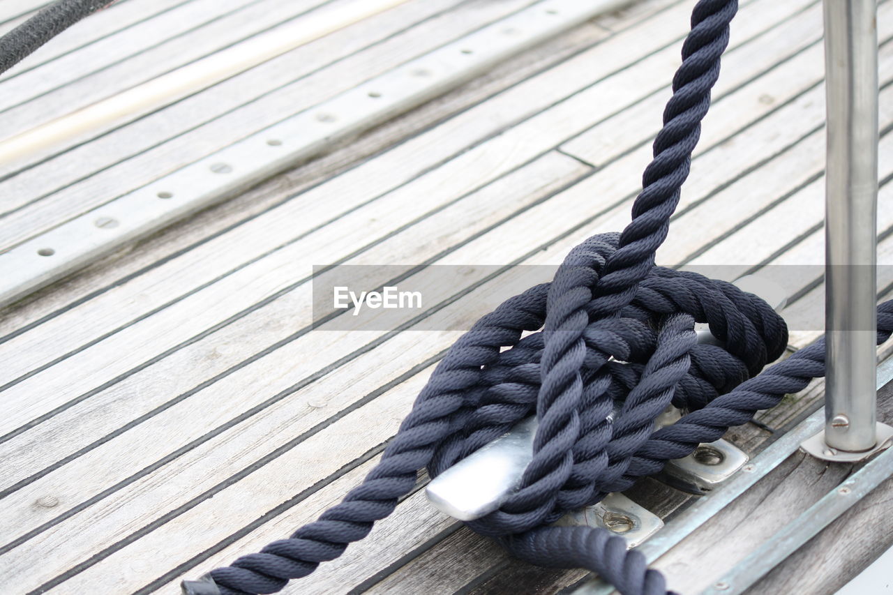 Close-up of rope tied on wood