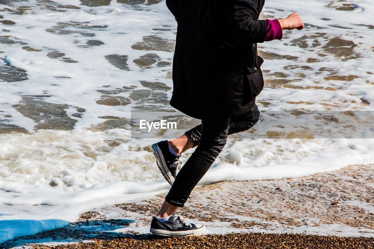 Woman jumping on beach