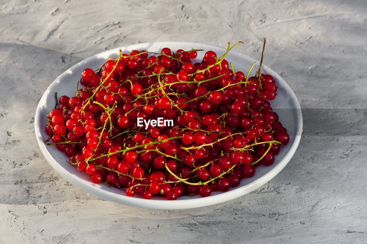 red, food and drink, food, healthy eating, wellbeing, plant, fruit, produce, freshness, high angle view, no people, bowl, studio shot, red chili pepper, directly above, abundance, chili pepper, still life, vegetable, spice, indoors, large group of objects, berry, pepper