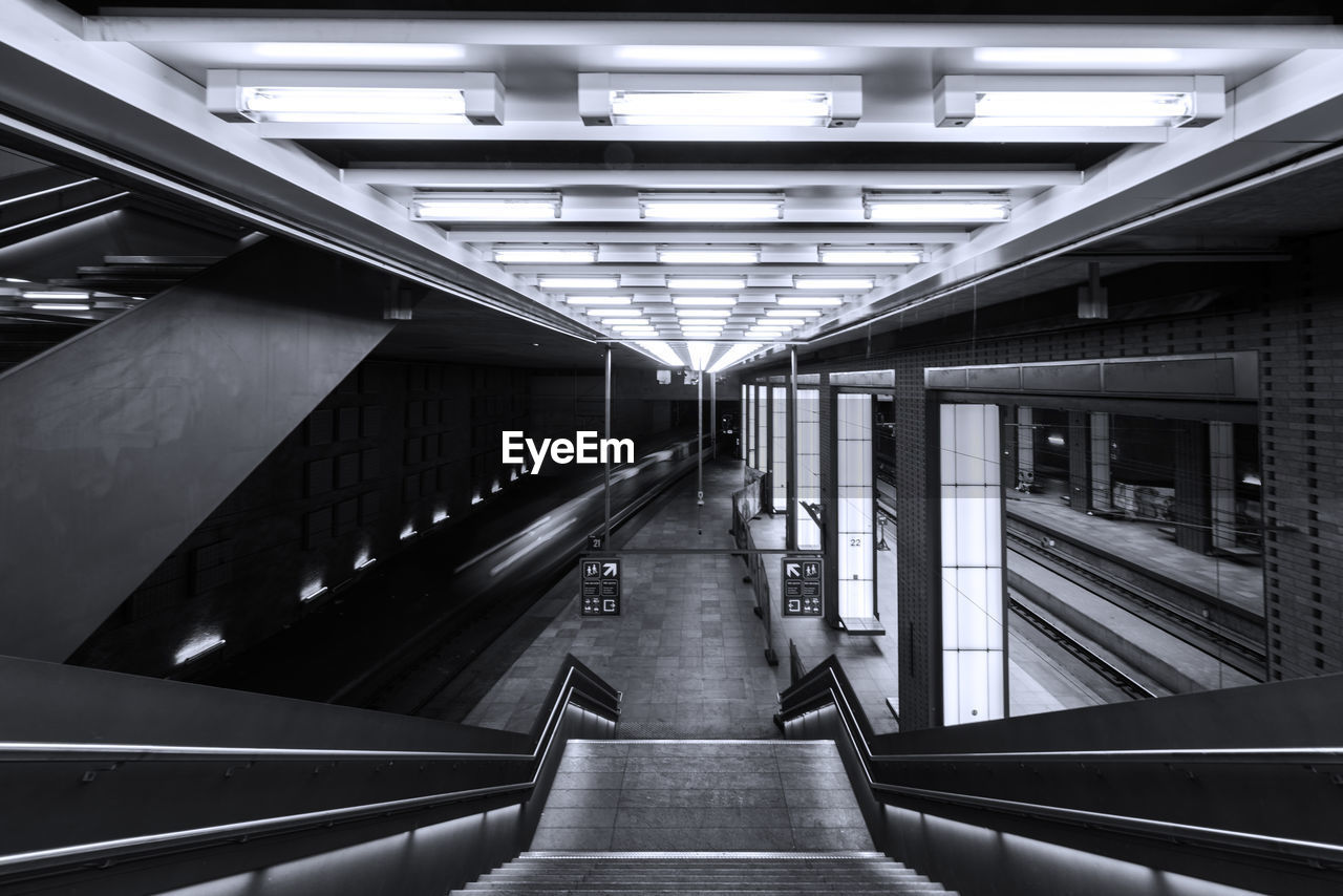Interior of illuminated railroad station platform