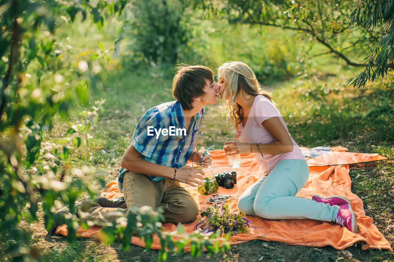 Couple kissing on field