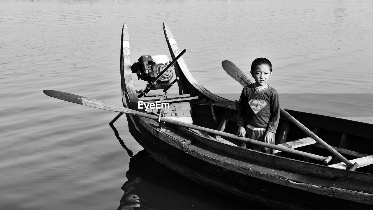 MAN SITTING IN BOAT