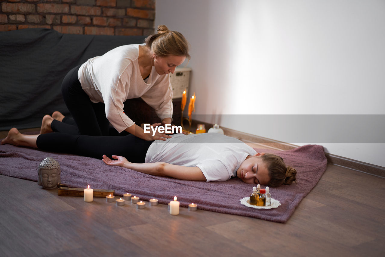 WOMAN LYING DOWN ON TABLE