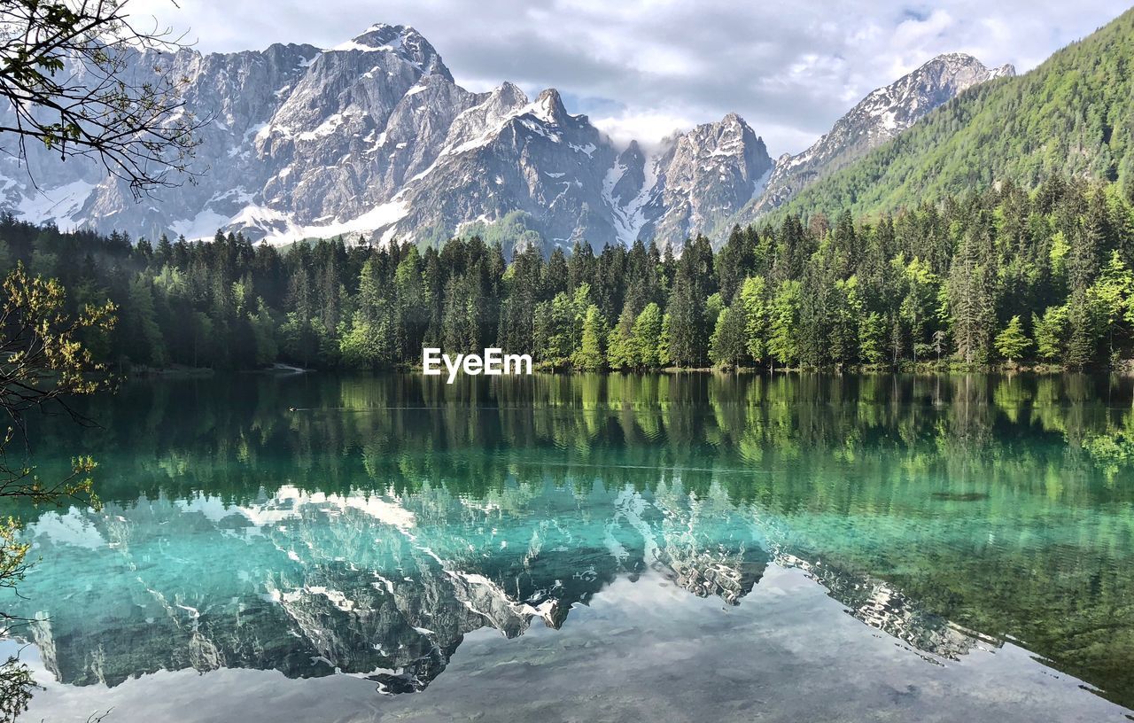 Scenic view of lake and snowcapped mountains