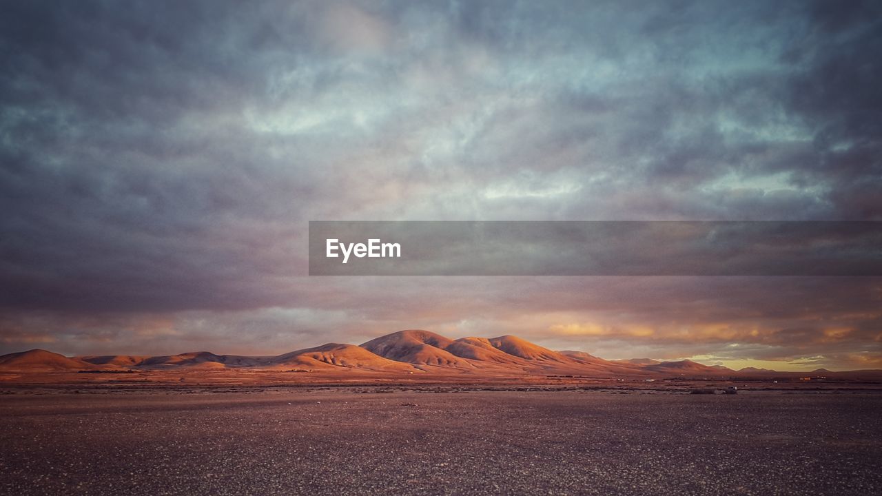 Scenic view of dramatic sky over desert