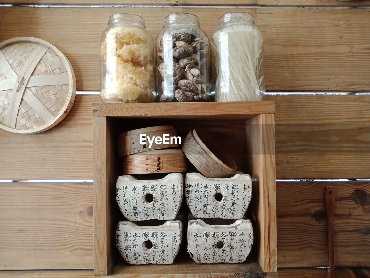 Food in jars on rack against wall