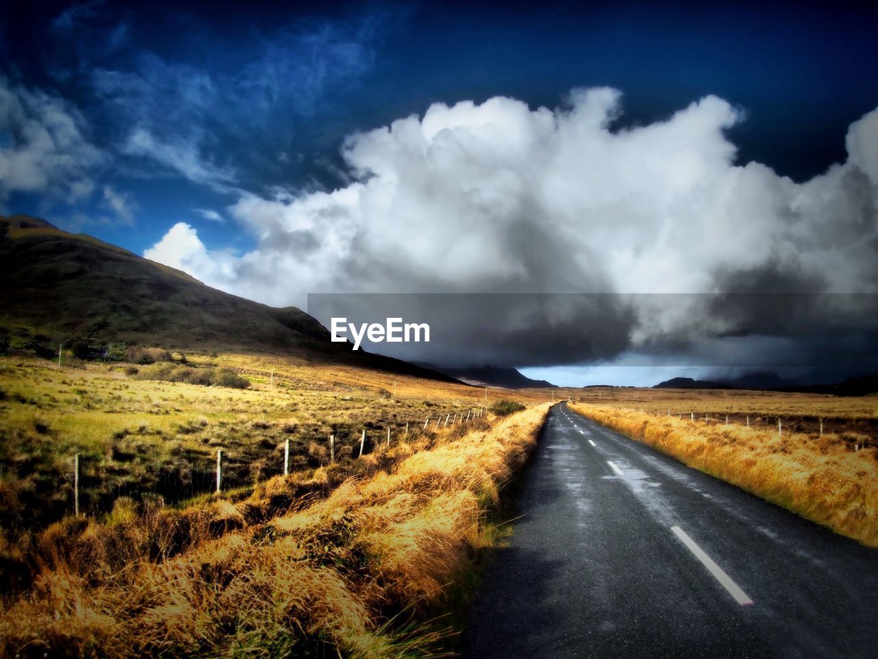 ROAD PASSING THROUGH RURAL LANDSCAPE