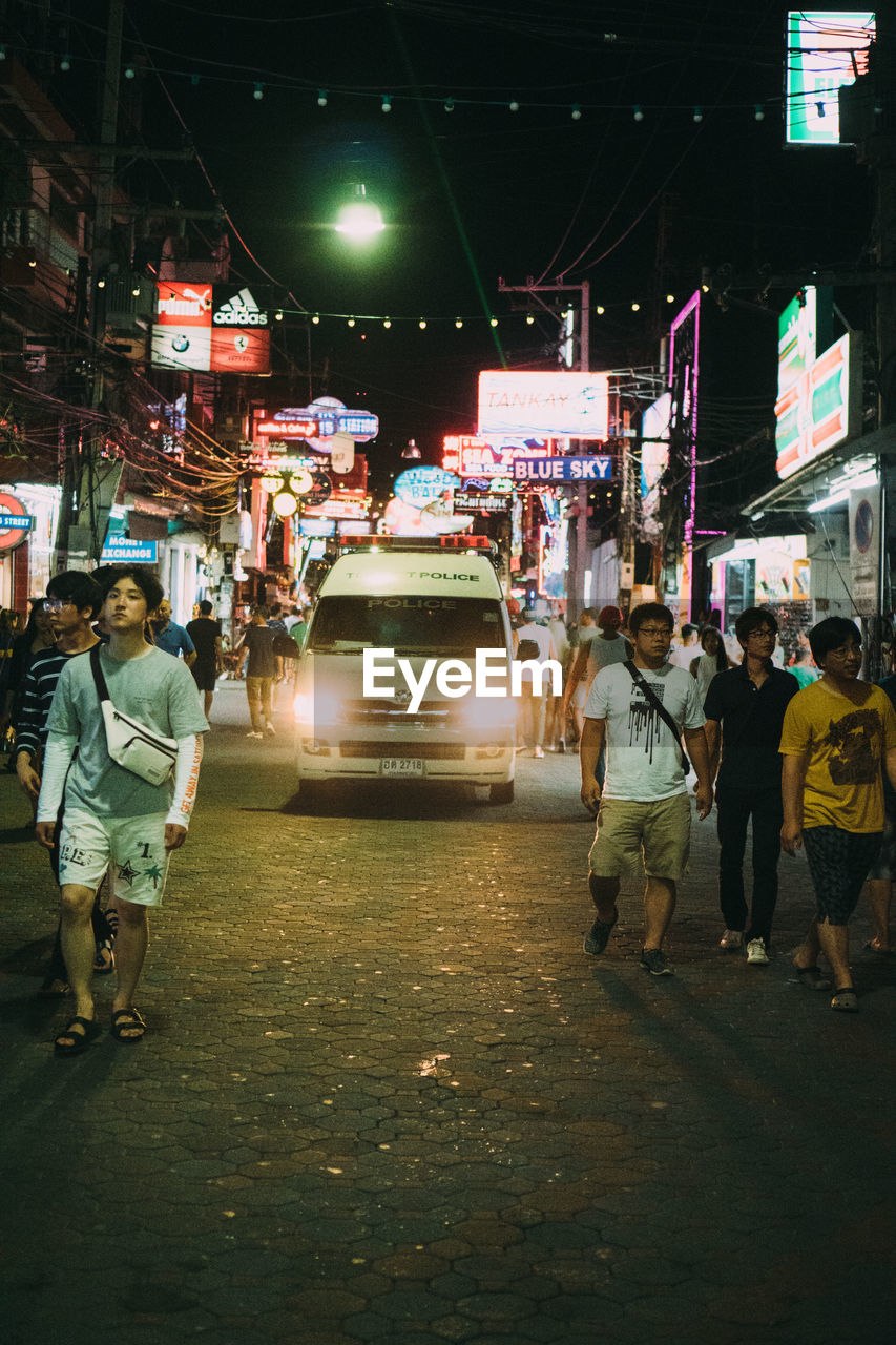 PEOPLE ON STREET AT NIGHT