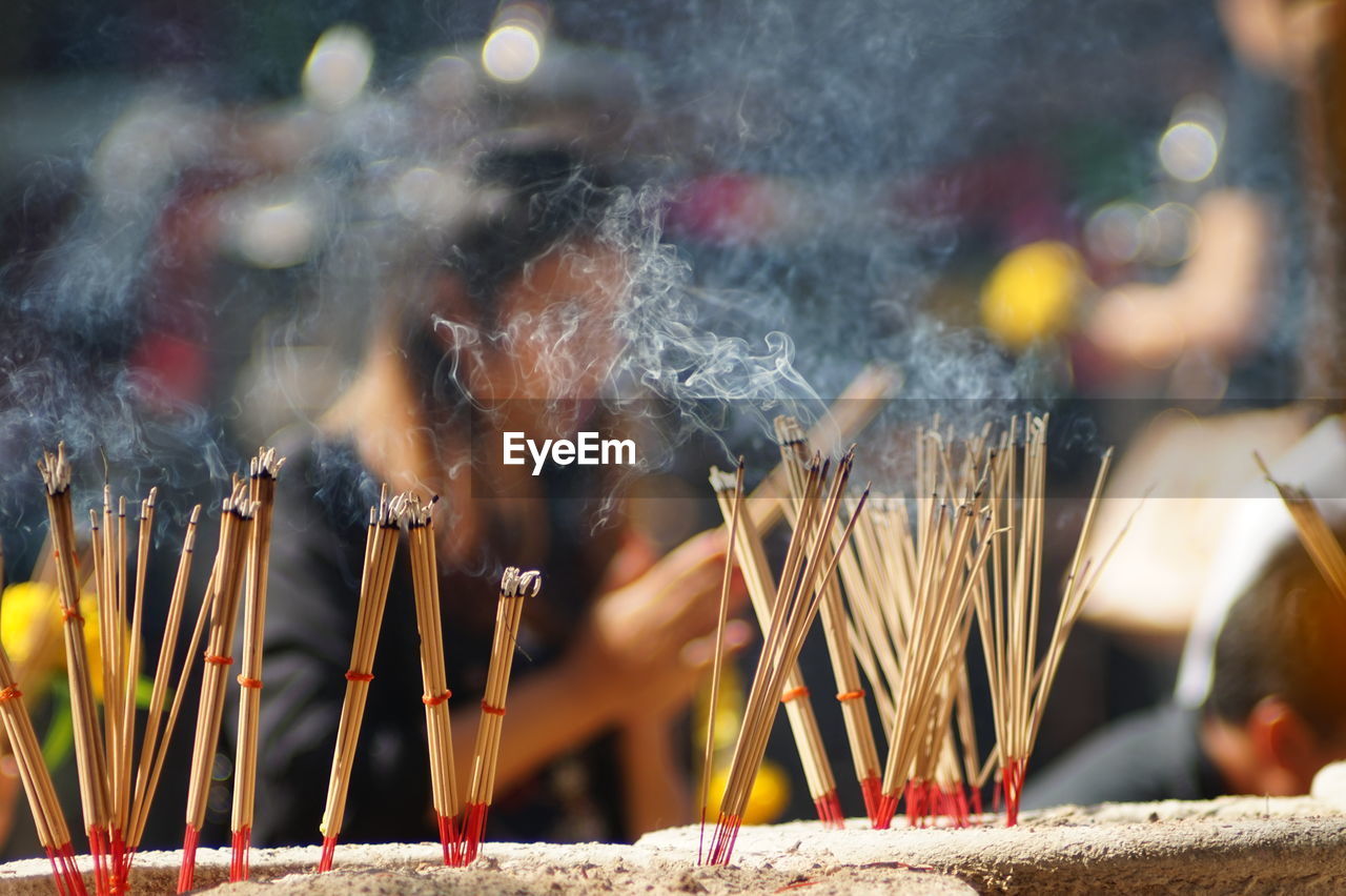 Close-up of lit candles in temple