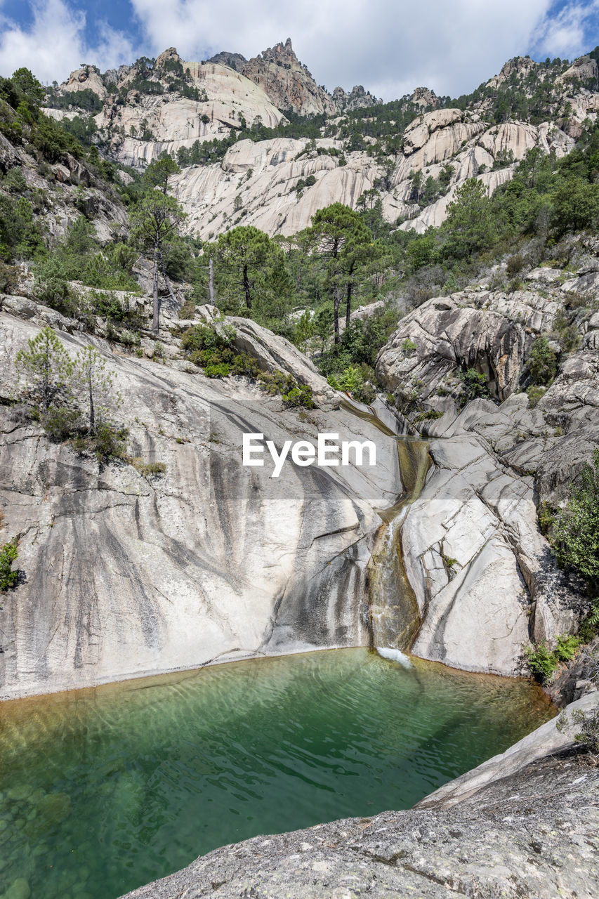 Waterfall and natural pool in purcaraccia canyon in bavella during summer. corsica, france