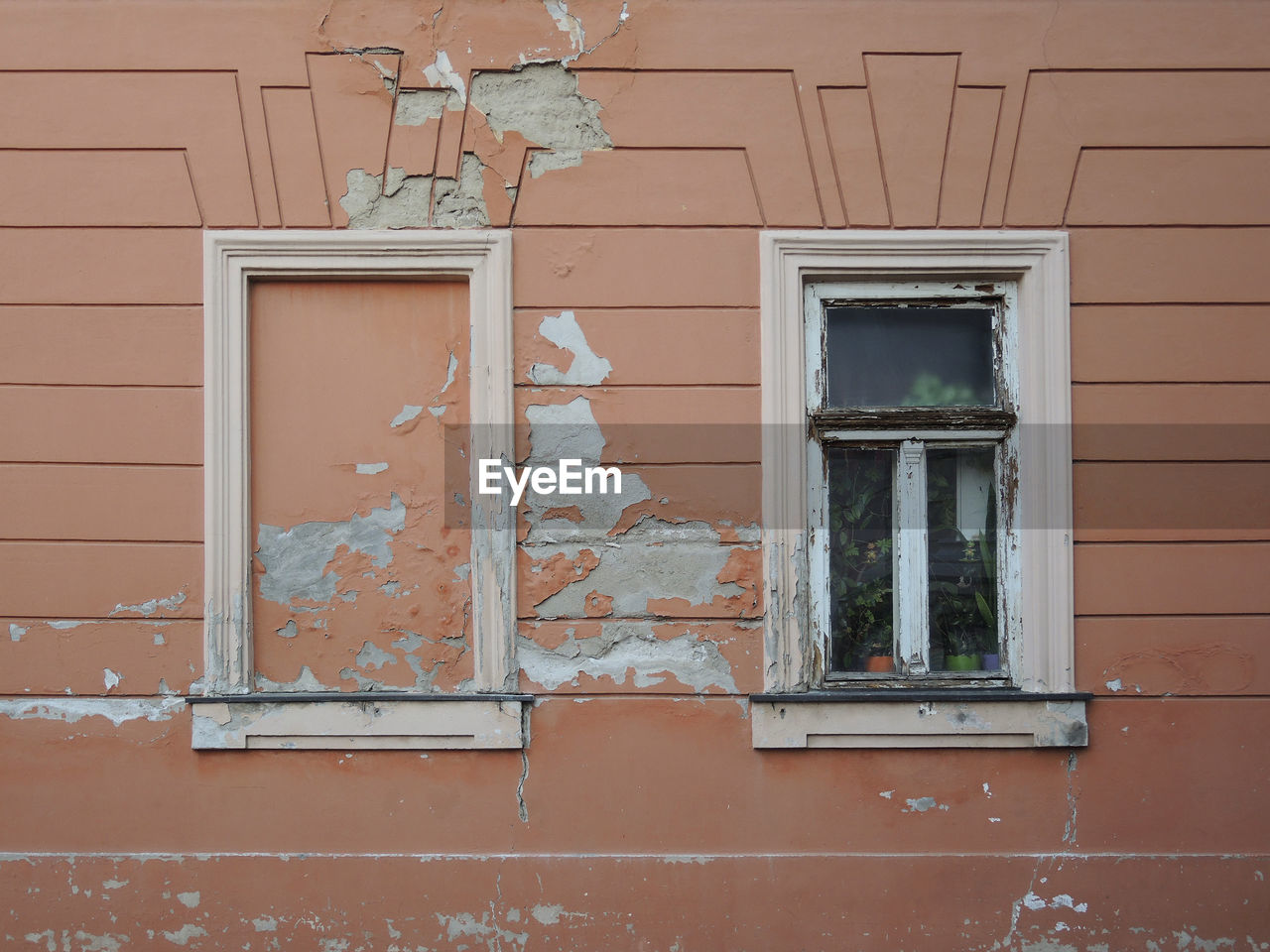 Window and empty space for other on the damaged wall 