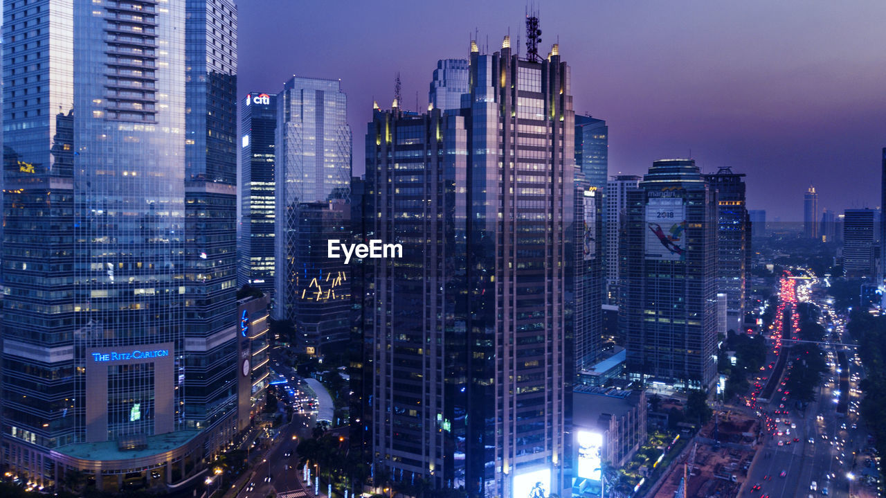 Aerial view of illuminated buildings in city at night