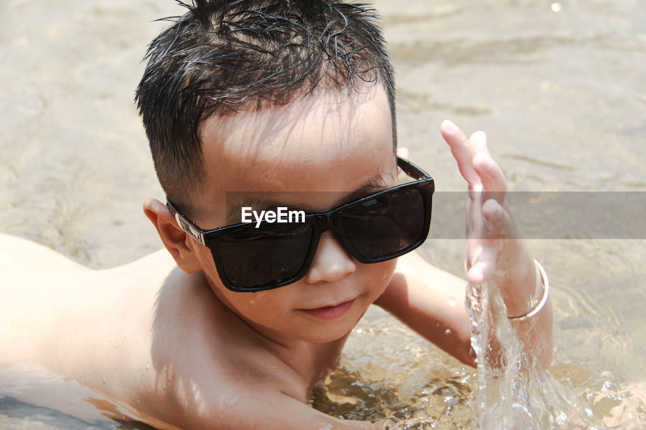 Cute boy lying on seashore