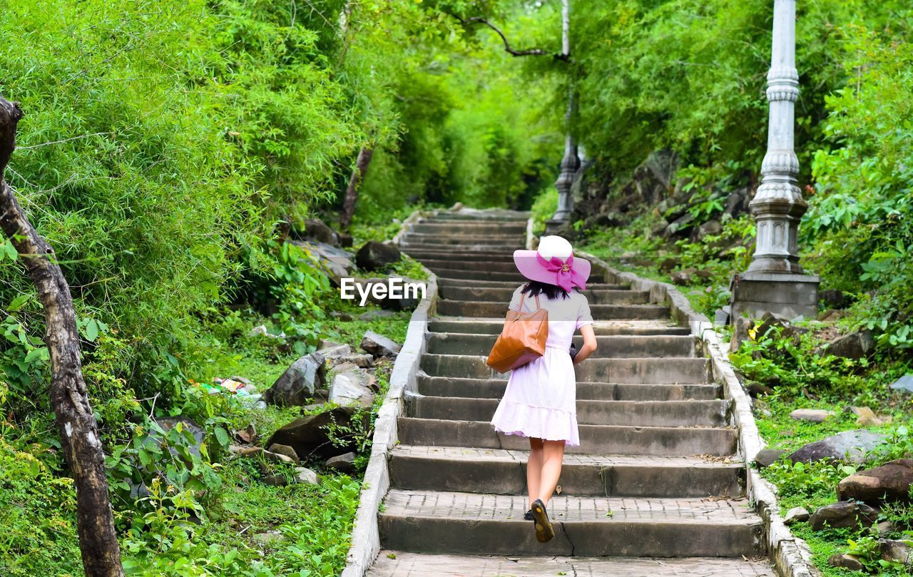 WOMAN STANDING BY STEPS