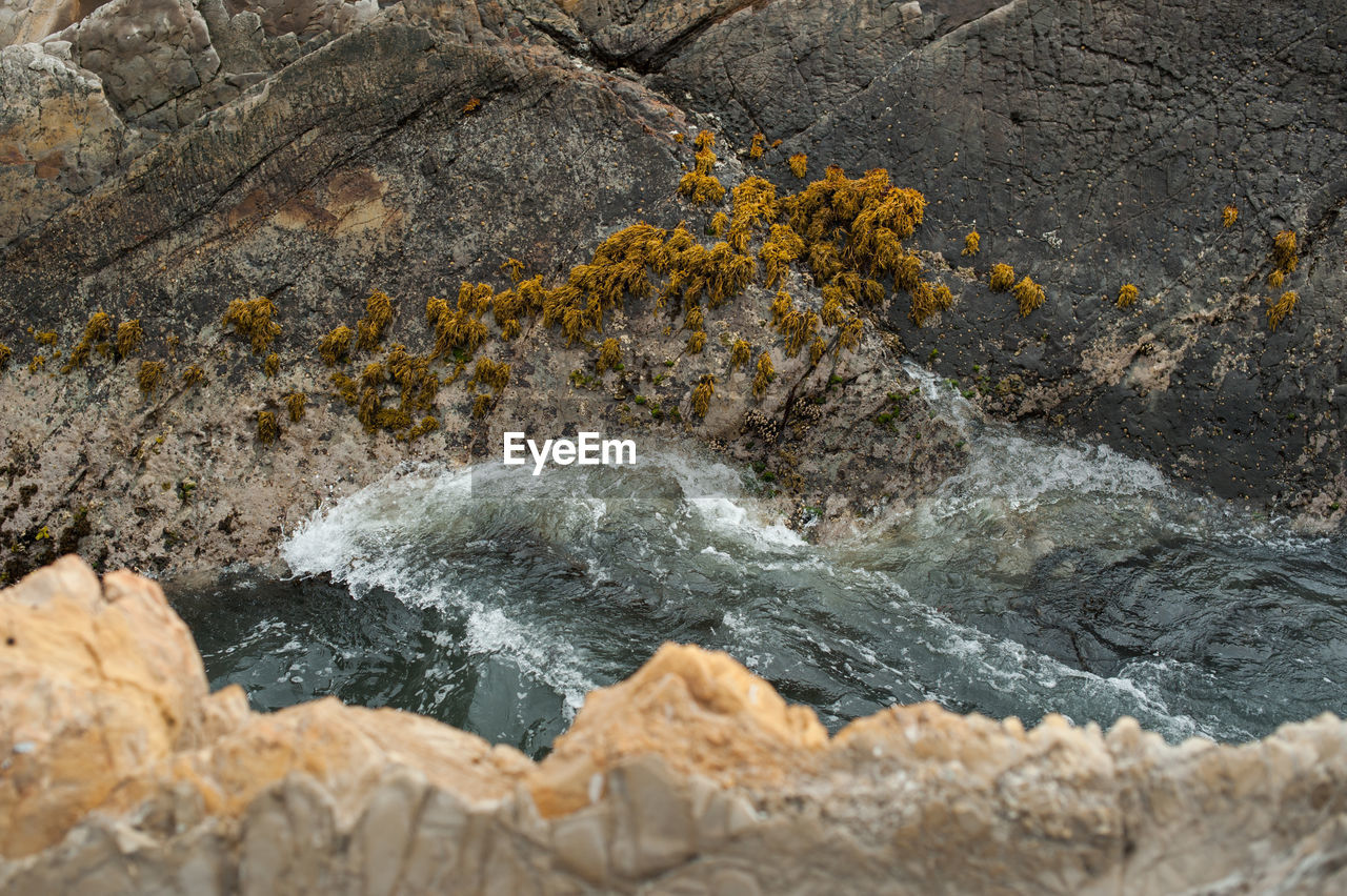 High angle view of rock formation by sea