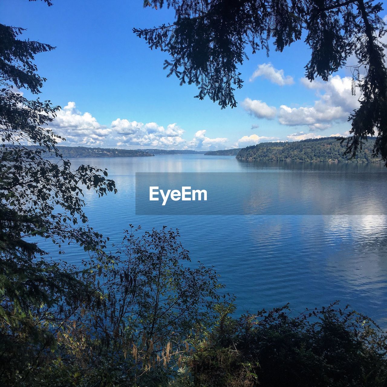 SCENIC VIEW OF CALM LAKE AGAINST SKY