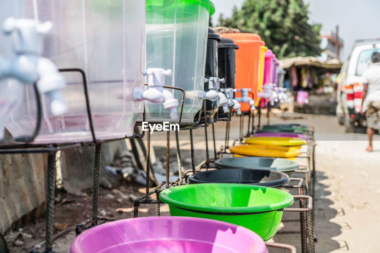 Empty containers under faucets outdoors