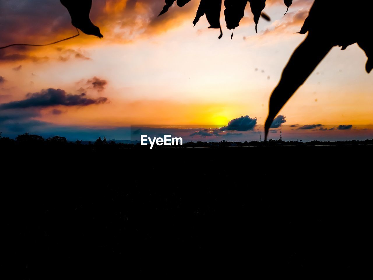 SCENIC VIEW OF SILHOUETTE LANDSCAPE AGAINST DRAMATIC SKY